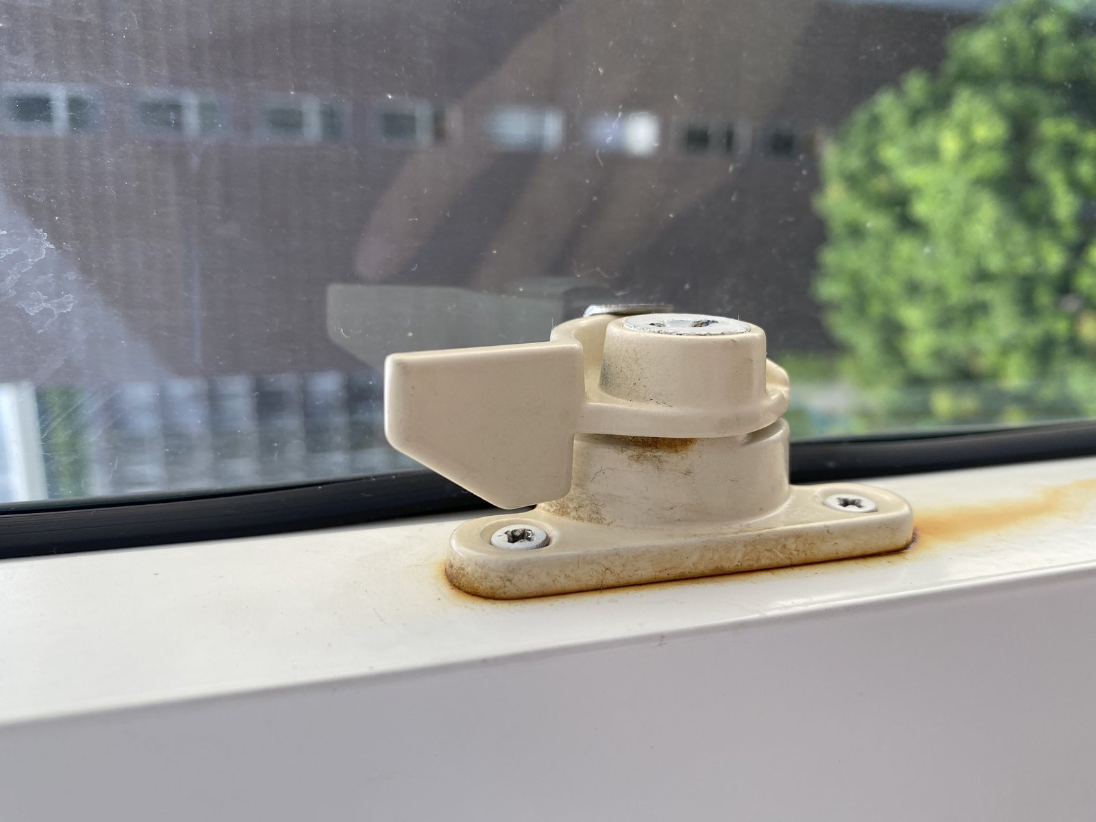 Rusted window latch documented at move-in — pre-existing condition on record